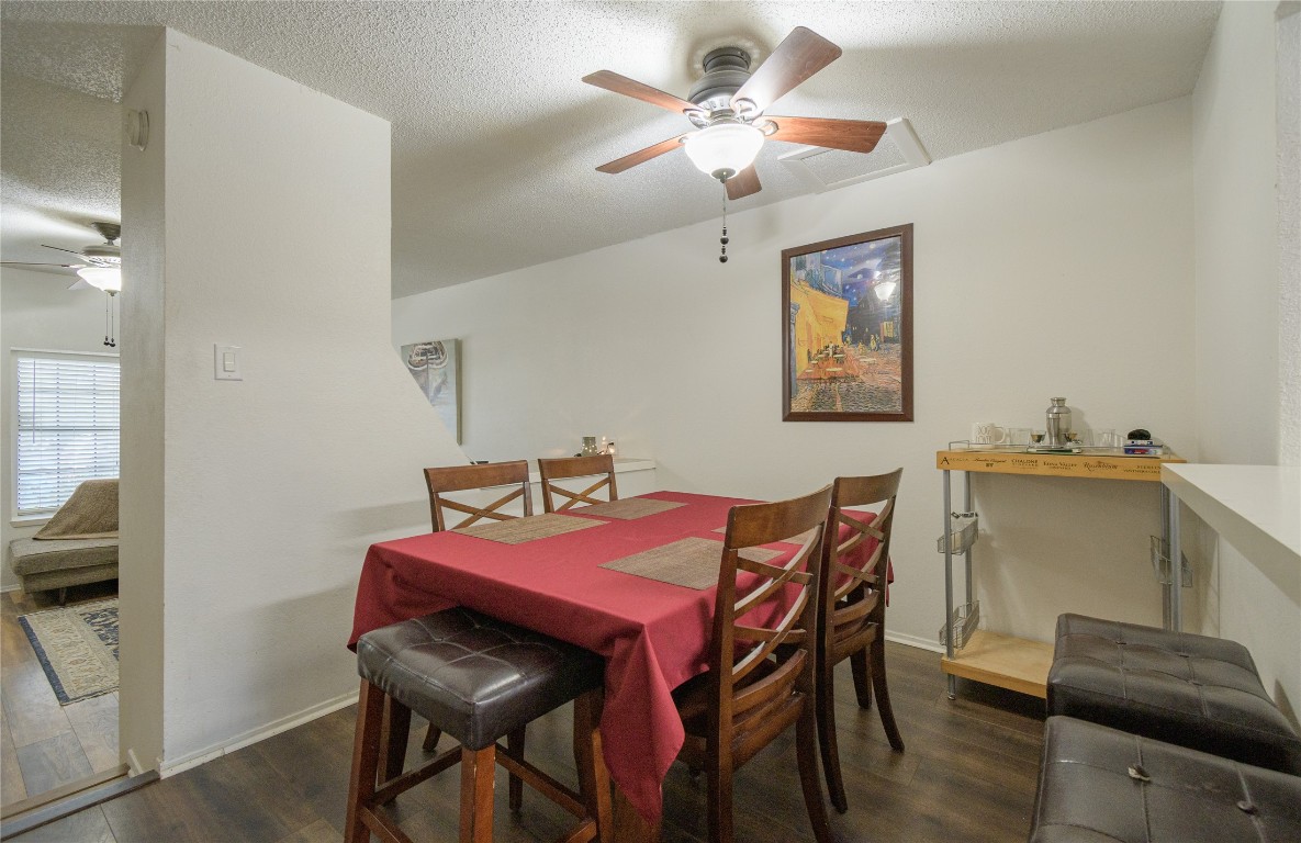 1411 Gracy Farms Lane, Unit 14 Austin, TX 78758 - Photo 6 of 16 a view of a dining room with furniture and a chandelier fan