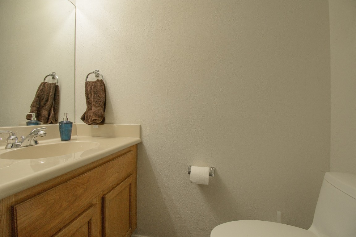 1411 Gracy Farms Lane, Unit 14 Austin, TX 78758 - Photo 7 of 16 a bathroom with a toilet sink and mirror