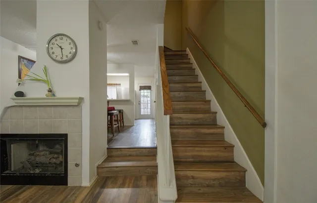 a view of entryway and hall with wooden floor