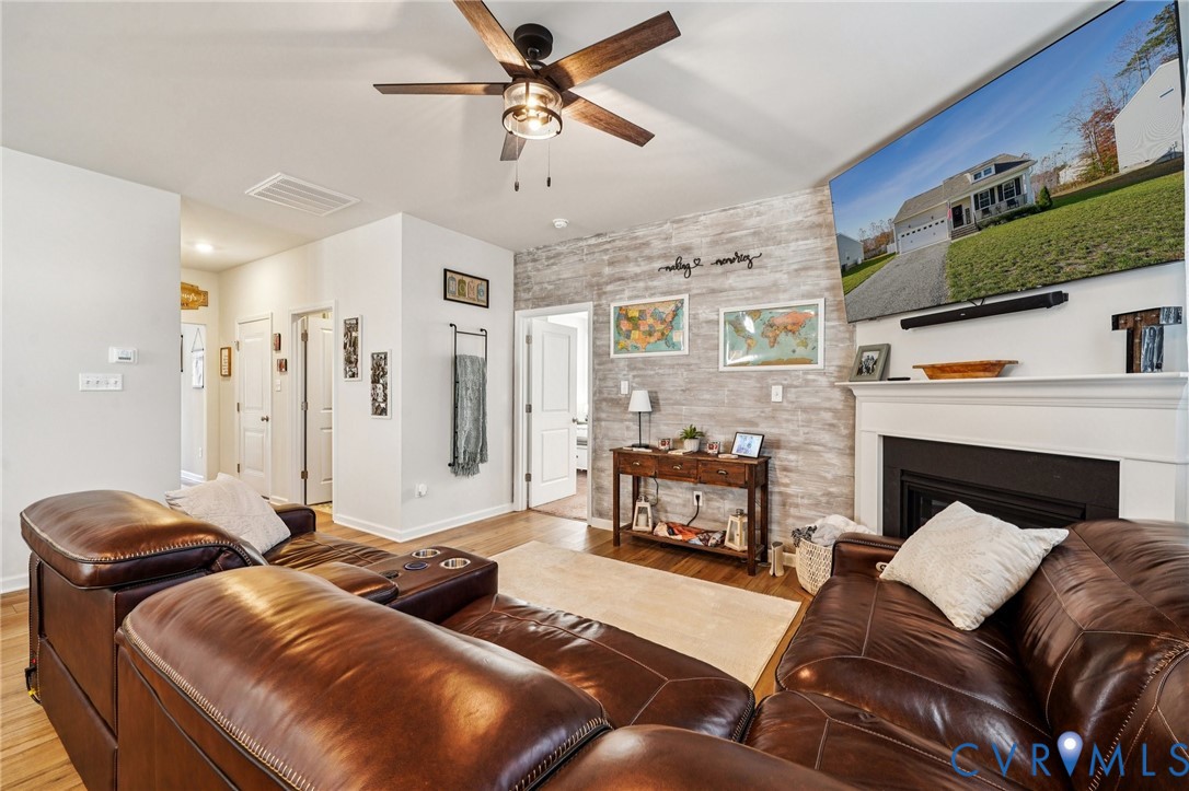 243 Bellevue Circle Aylett, VA 23009 - Photo 15 of 34 a living room with furniture ceiling fan and a fireplace
