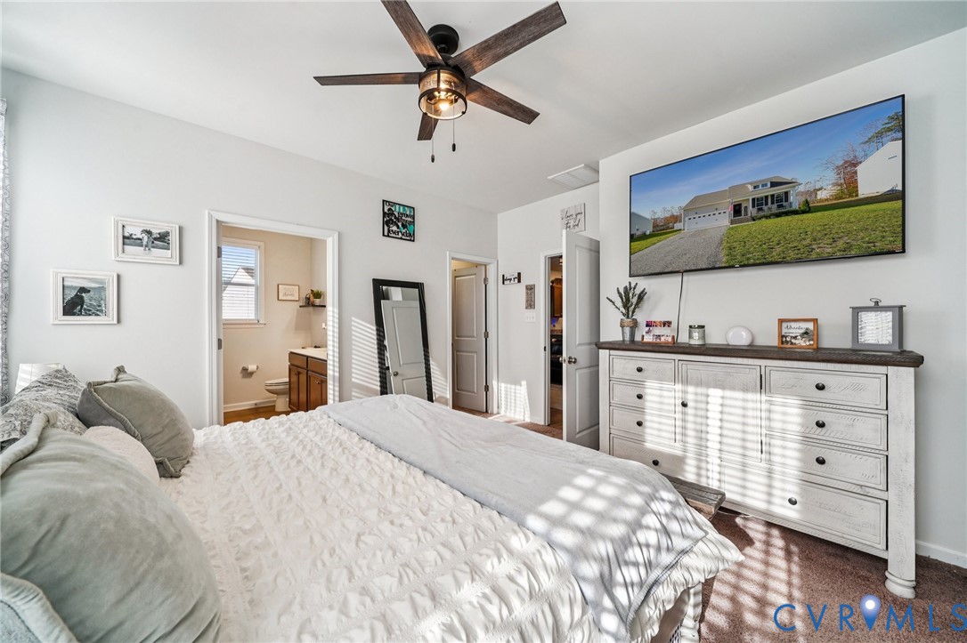 243 Bellevue Circle Aylett, VA 23009 - Photo 18 of 34 a bedroom with a bed and a flat screen tv