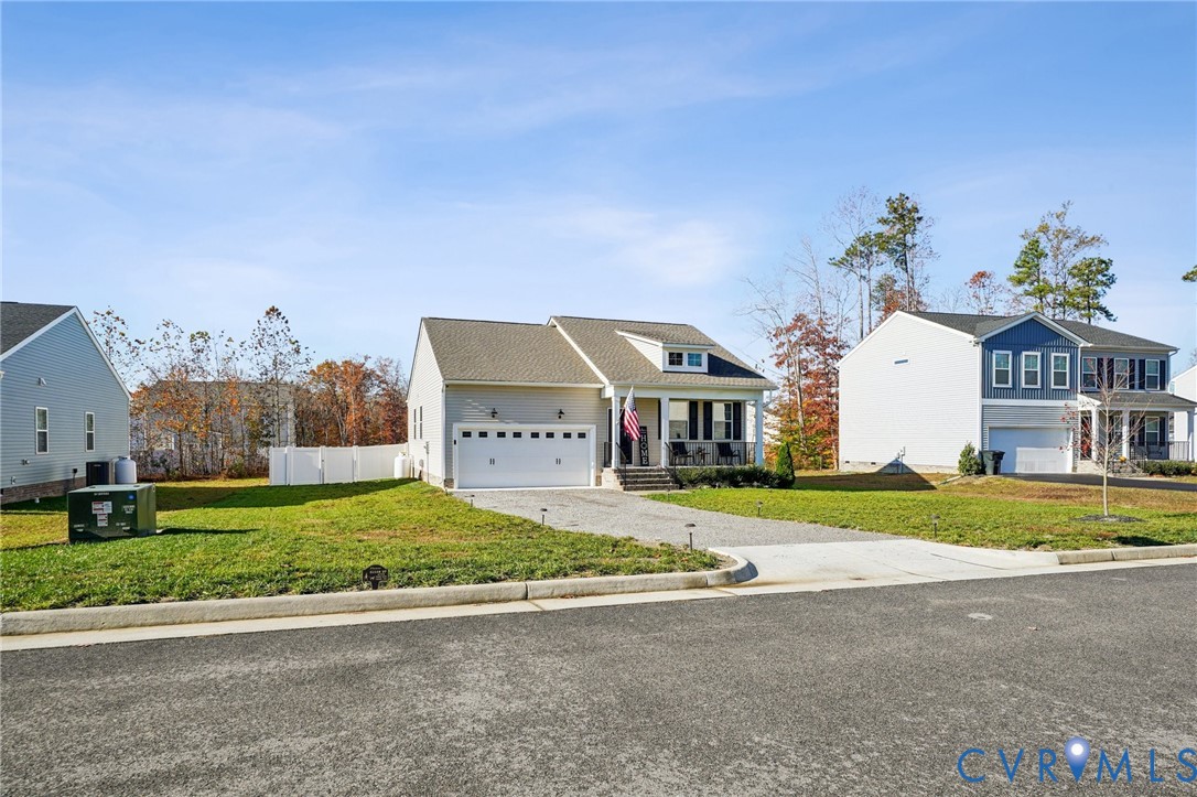 243 Bellevue Circle Aylett, VA 23009 - Photo 32 of 34 a front view of a house with a yard and garage