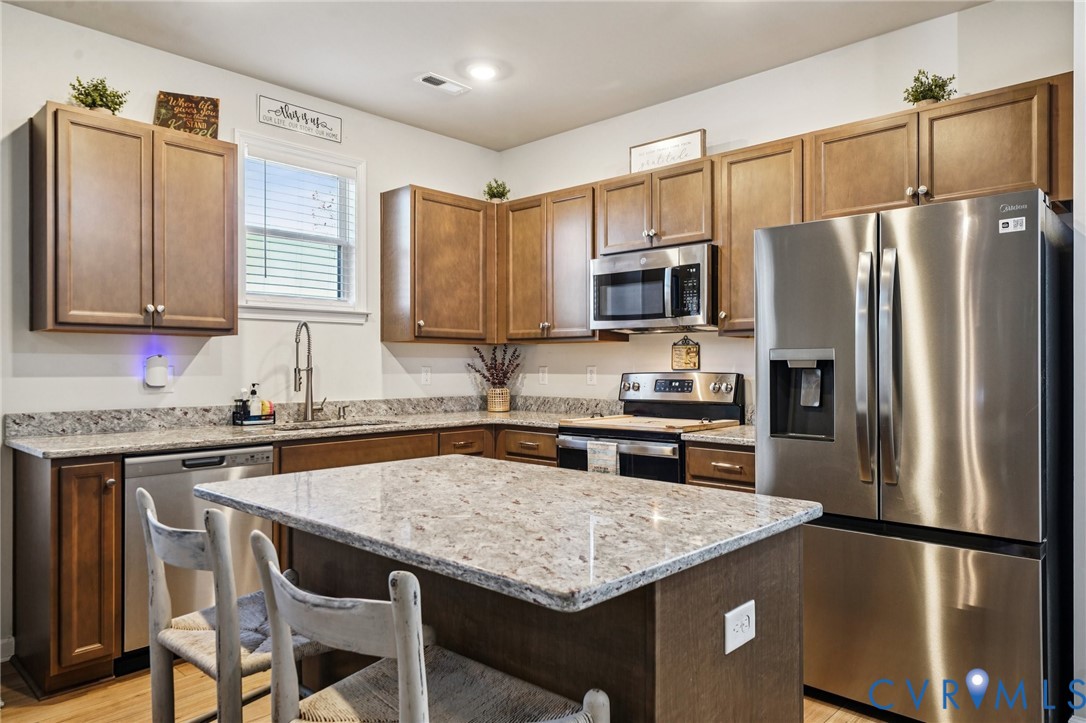 243 Bellevue Circle Aylett, VA 23009 - Photo 8 of 34 a kitchen with a refrigerator a sink a stove a microwave and cabinets