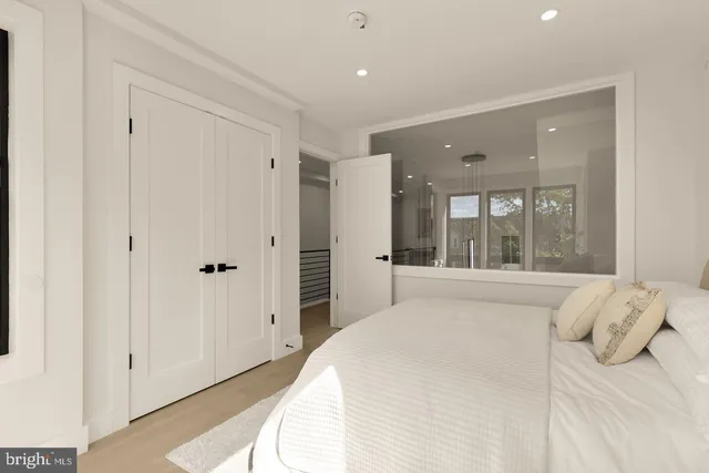 a large white bed in a white room