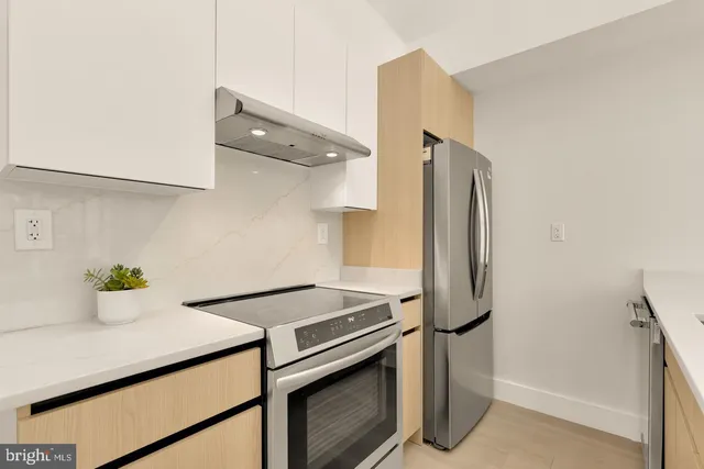 a kitchen with a sink and white cabinets
