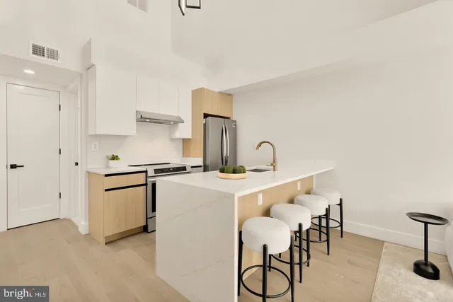 a kitchen with a sink cabinets and appliances