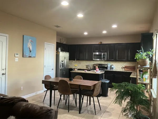 a kitchen with a table and chairs in it