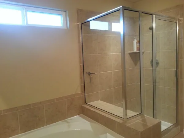 a bathroom with a glass shower door