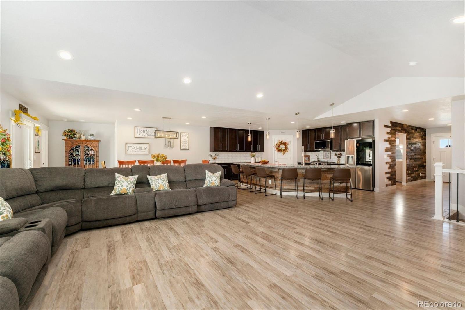 16477 Stoneleigh Road Platteville, CO 80651 - Photo 13 of 37 a living room with furniture and wooden floor