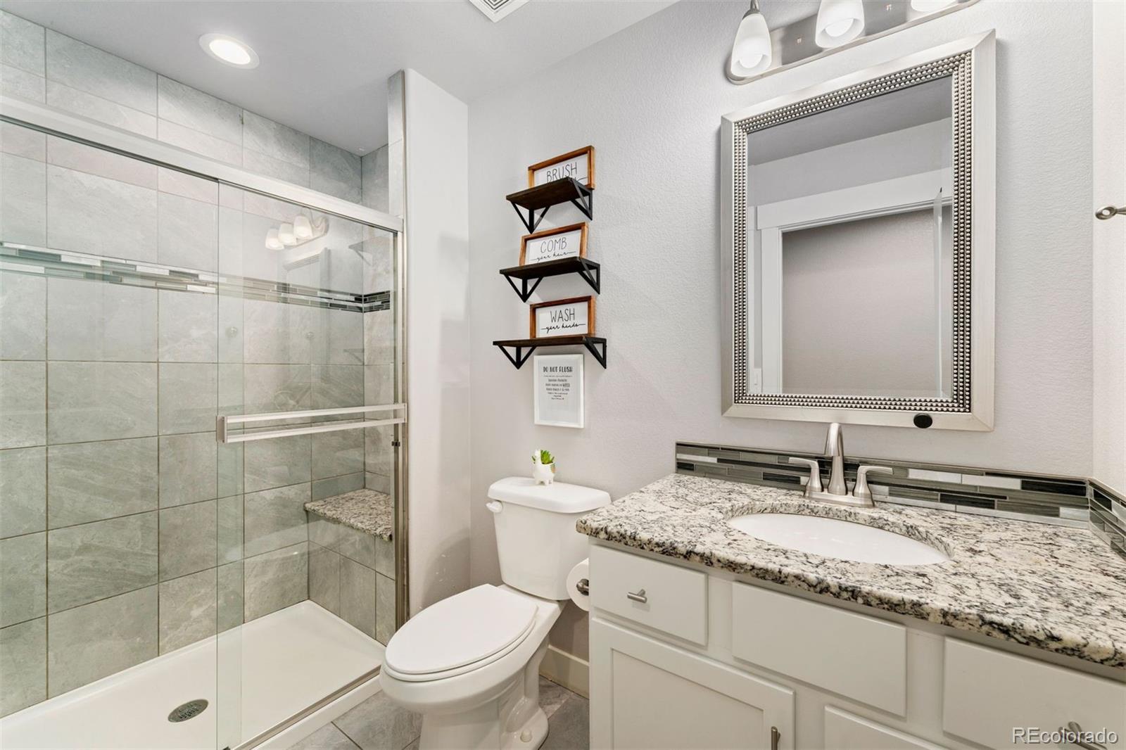 16477 Stoneleigh Road Platteville, CO 80651 - Photo 16 of 37 a bathroom with a granite countertop sink toilet and shower
