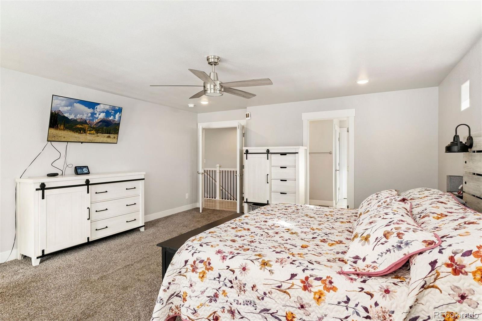 16477 Stoneleigh Road Platteville, CO 80651 - Photo 17 of 37 a bedroom with a bed and a flat screen tv