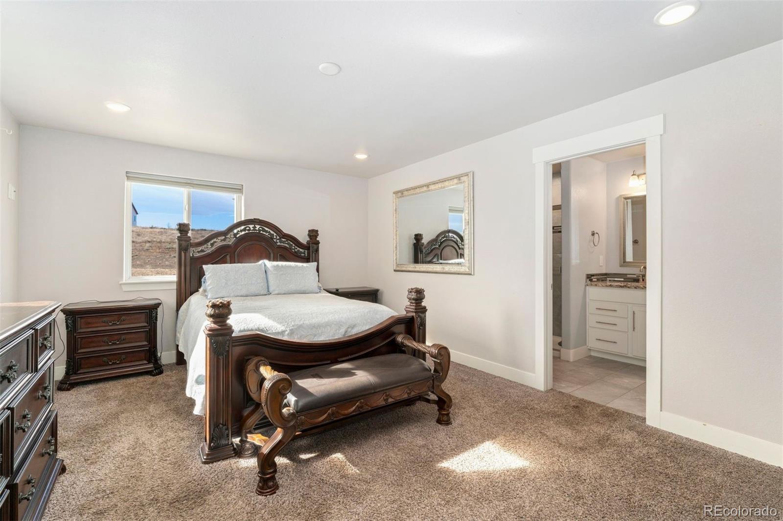16477 Stoneleigh Road Platteville, CO 80651 - Photo 21 of 37 a bedroom with a bed and a cabinets