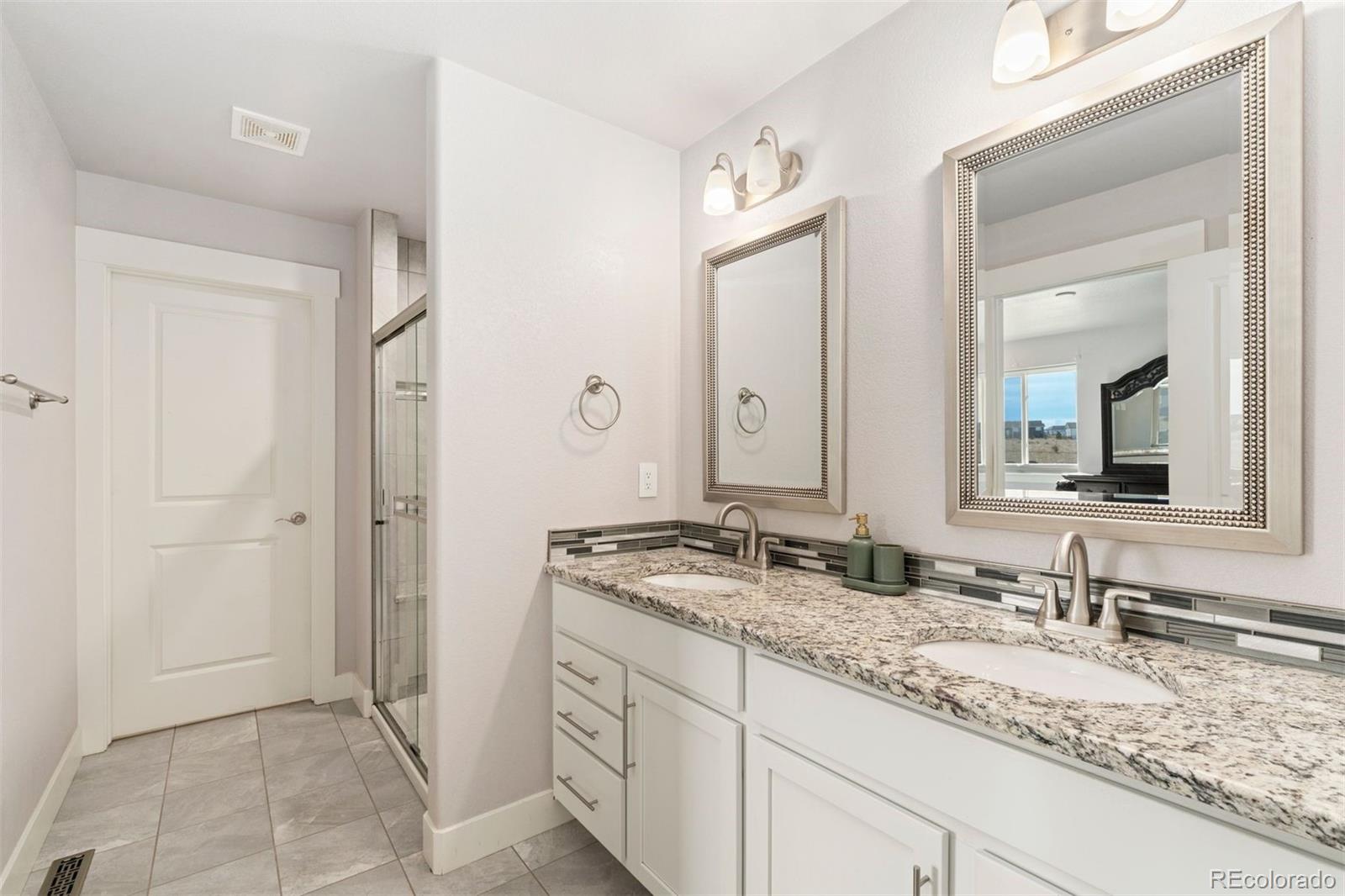 16477 Stoneleigh Road Platteville, CO 80651 - Photo 26 of 37 a bathroom with a granite countertop sink and a mirror