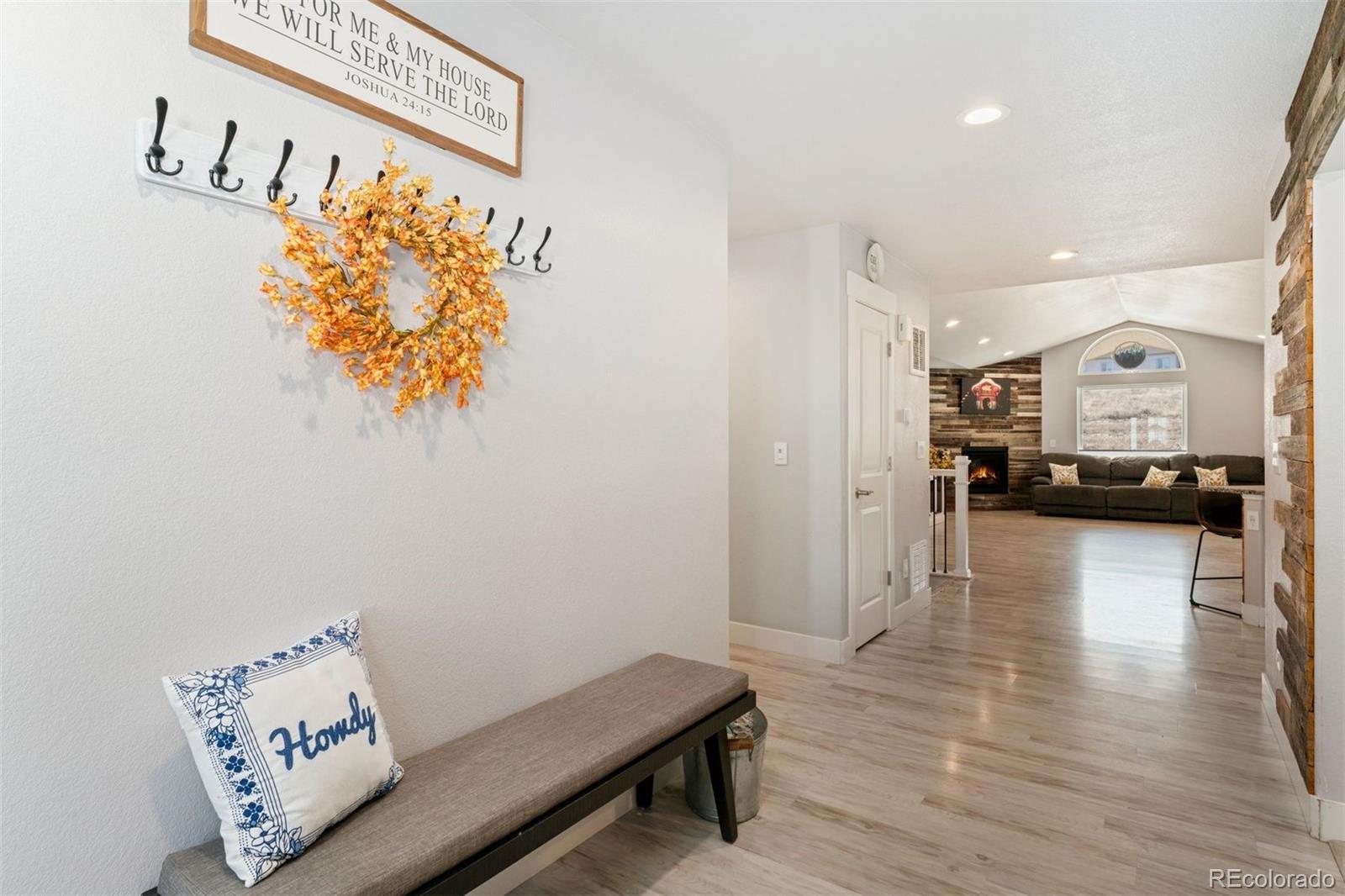 16477 Stoneleigh Road Platteville, CO 80651 - Photo 5 of 37 a living room with furniture and a wooden floor