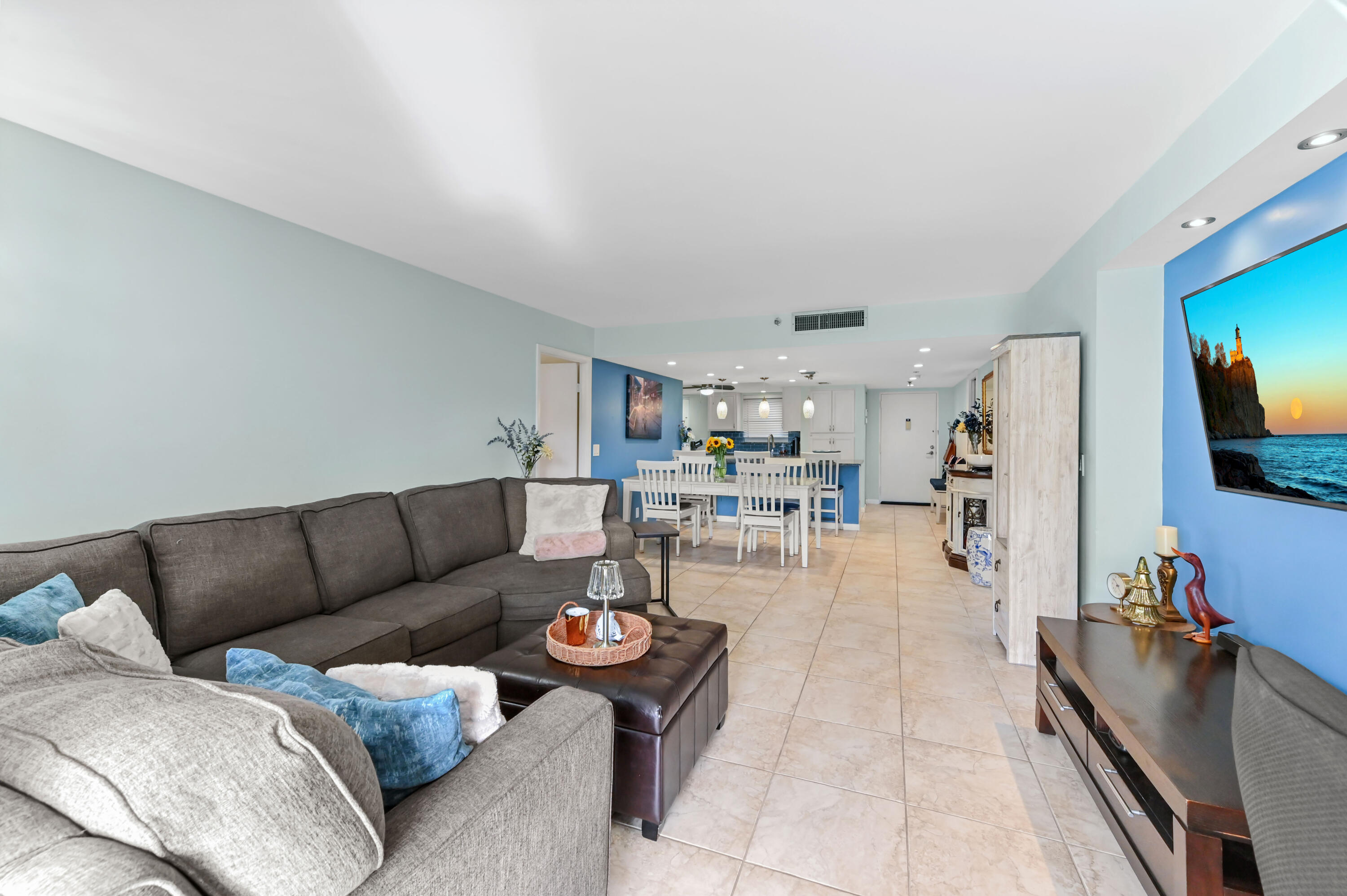 198 Northwest 67th Street, Unit 207 Boca Raton, FL 33487 - Photo 18 of 42 a living room with furniture and a flat screen tv