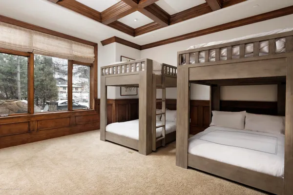 a bedroom with furniture and large window