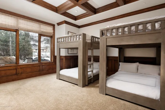 a bedroom with furniture and large window