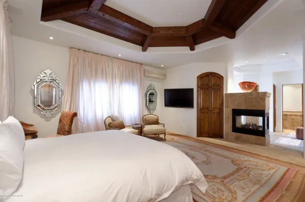 a bedroom with bed and wooden floor
