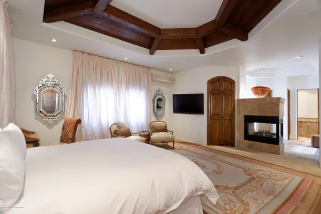 a bedroom with bed and wooden floor