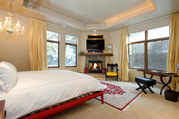 a bedroom with a bed and a television