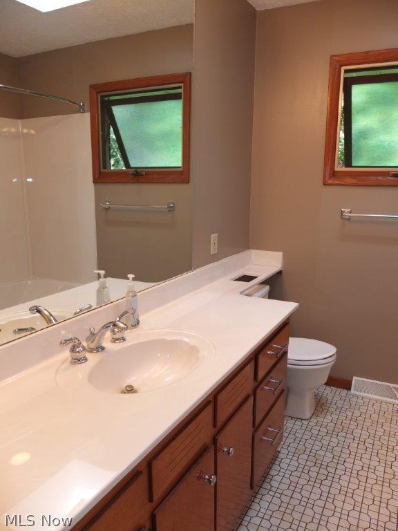 5891 Springlake Road Northwest Canton, OH 44718 - Photo 9 of 20 Full bath with skylight, tile floor and solid surface countertop.