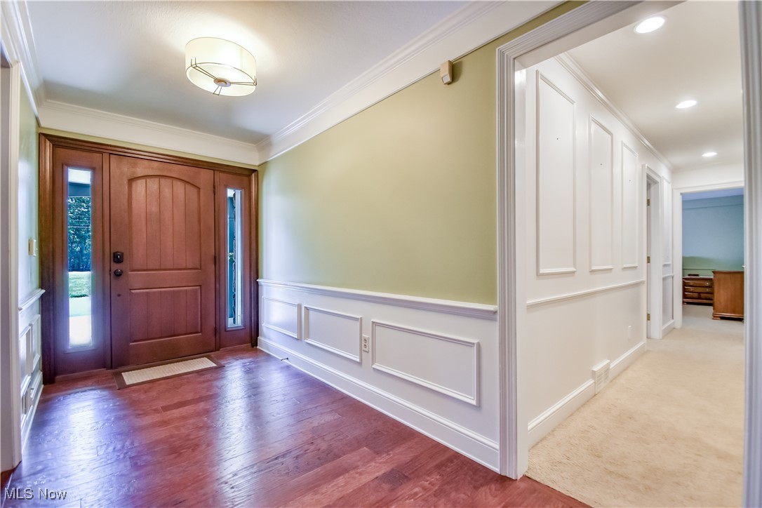 9715 Johnnycake Ridge Road Mentor, OH 44060 - Photo 4 of 50 Entrance foyer with ornamental molding, wood finished floors, wainscoting, and recessed lighting