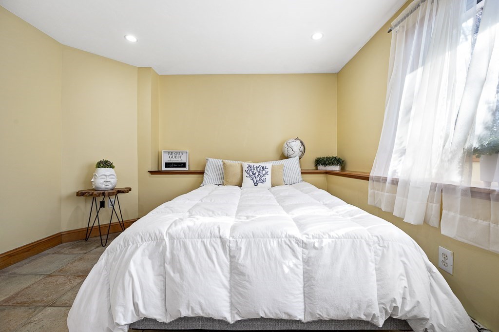 51 Pierce Road Sutton, MA 01590 - Photo 28 of 42 a bedroom with a bed and a table in it