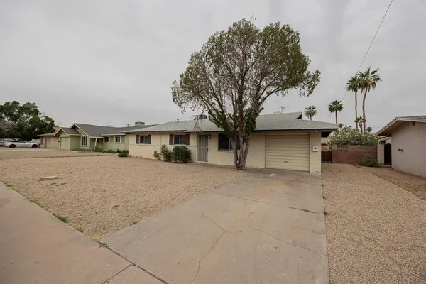 a view of a house with a yard and garage