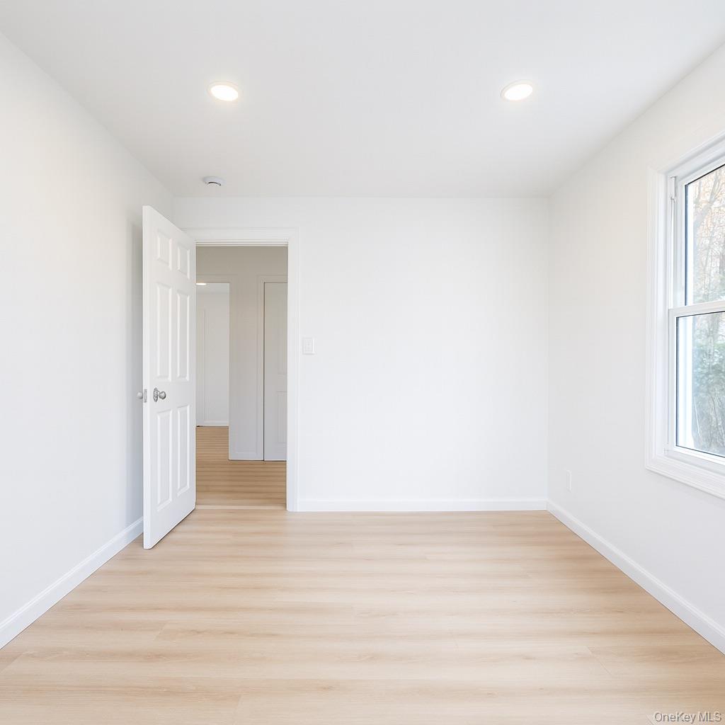 88 Cold Spring Road Liberty, NY 12754 - Photo 16 of 28 a view of an empty room with wooden floor and a window