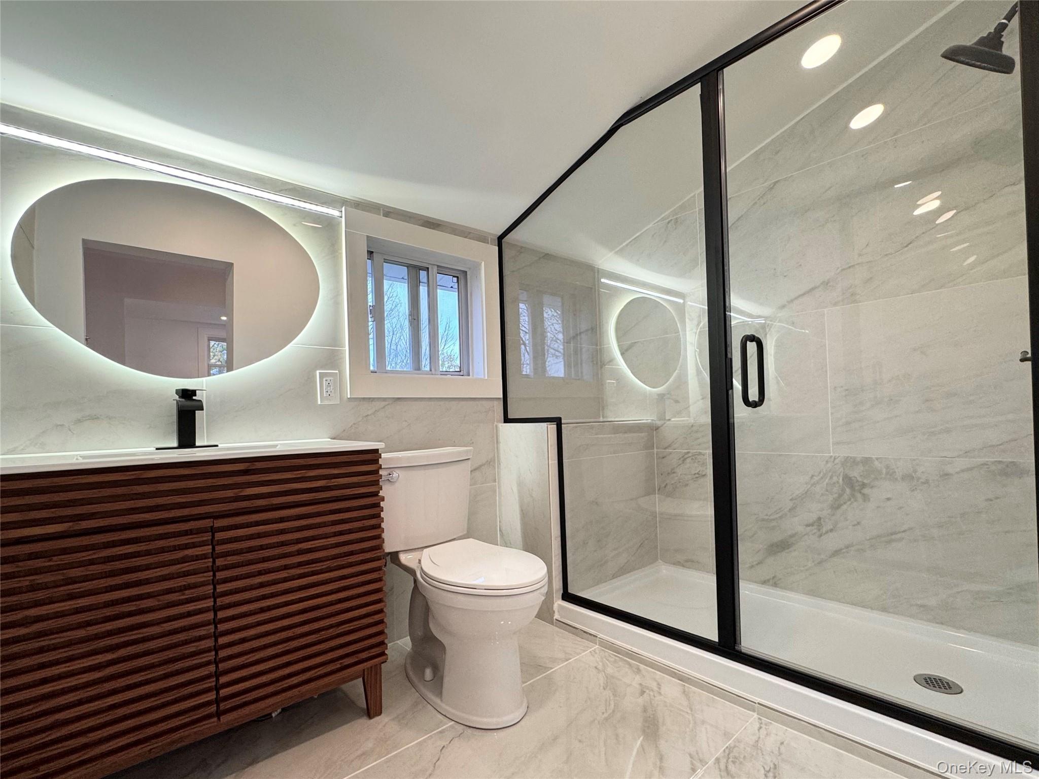 88 Cold Spring Road Liberty, NY 12754 - Photo 27 of 32 Full bathroom featuring a shower stall, vanity, and tile walls