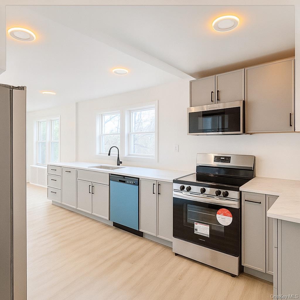 88 Cold Spring Road Liberty, NY 12754 - Photo 3 of 28 a kitchen with stainless steel appliances a stove a sink and a microwave