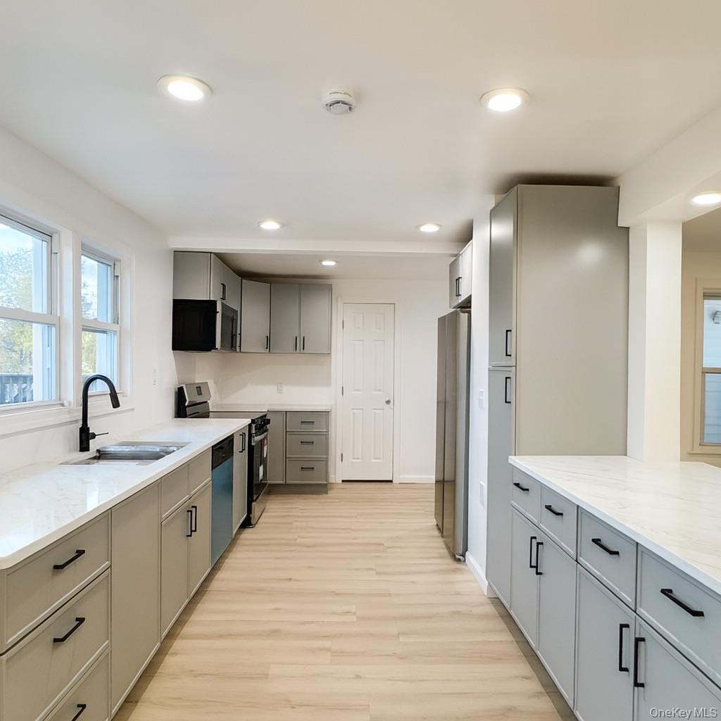 88 Cold Spring Road Liberty, NY 12754 - Photo 6 of 28 a large kitchen with a center island and stainless steel appliances
