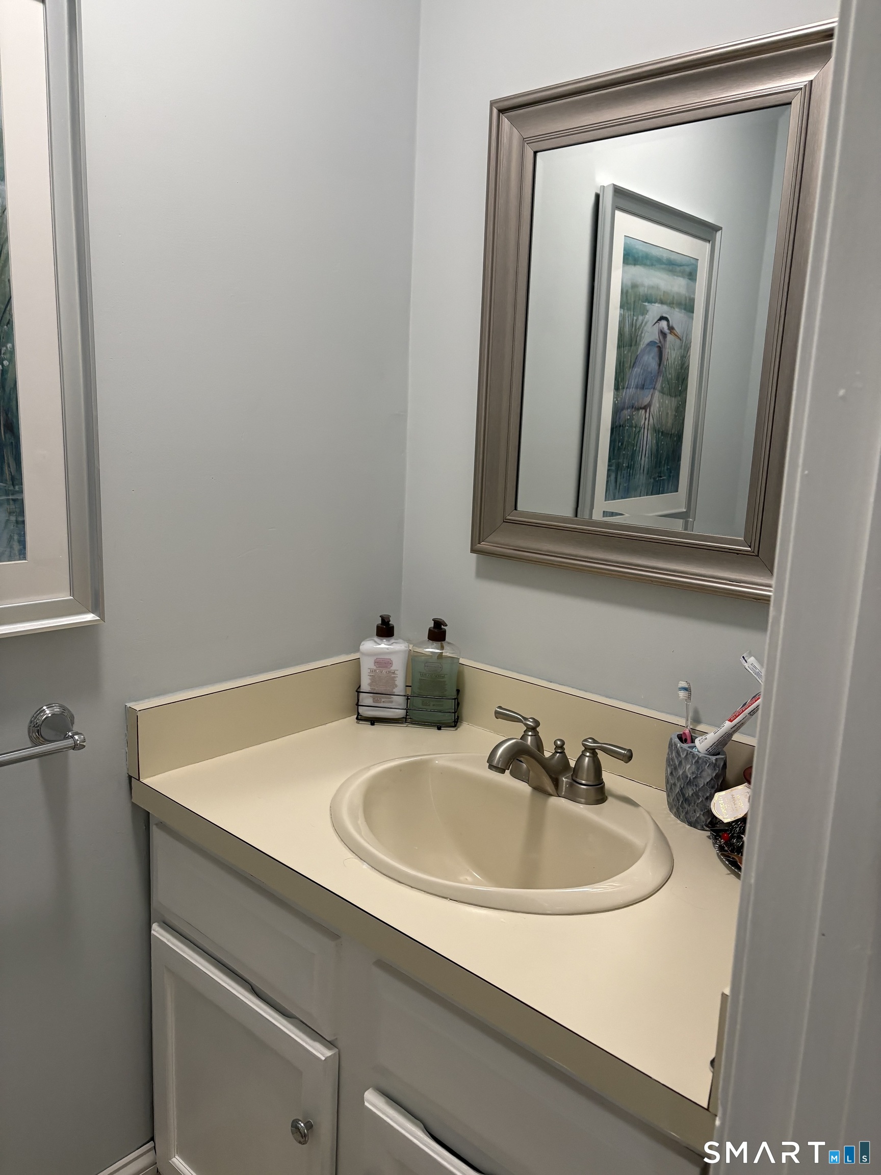 32 Upper Pattagansett Road, Unit 30 East Lyme, CT 06333 - Photo 18 of 28 a bathroom with a sink and a mirror