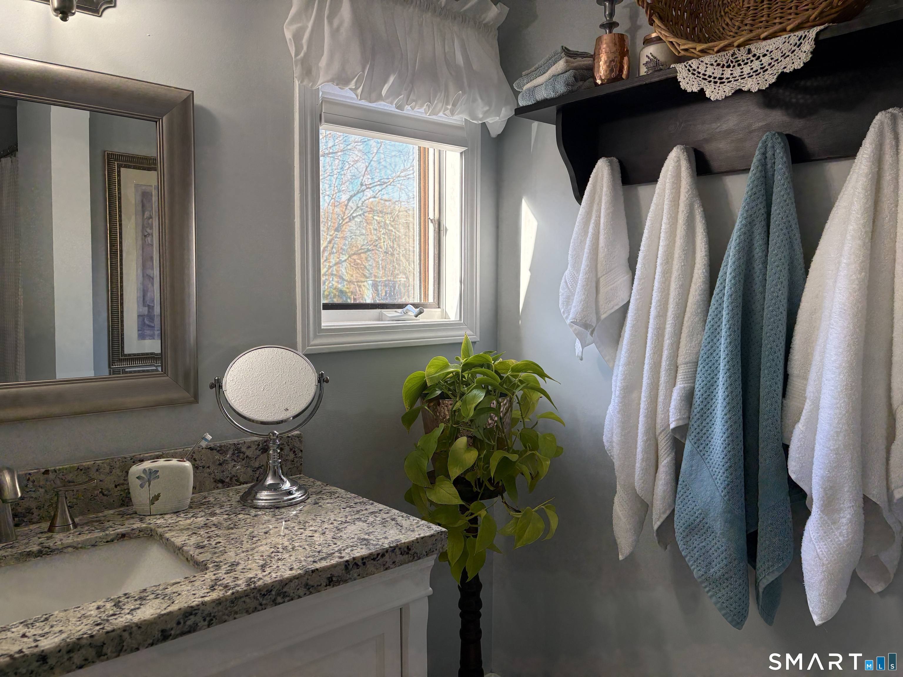 32 Upper Pattagansett Road, Unit 30 East Lyme, CT 06333 - Photo 19 of 28 a bathroom with a granite countertop sink a toilet and a mirror