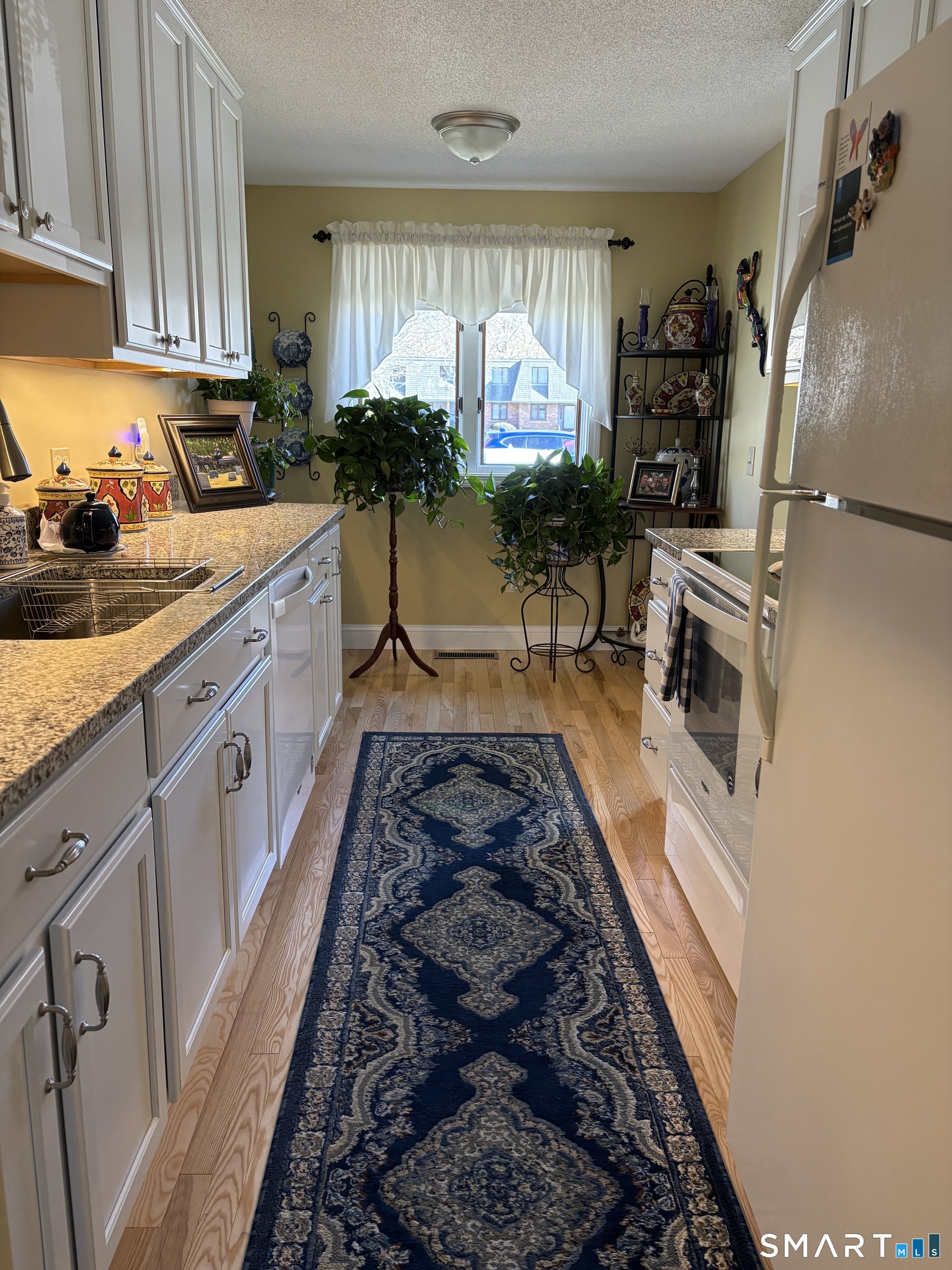 32 Upper Pattagansett Road, Unit 30 East Lyme, CT 06333 - Photo 4 of 28 a kitchen with sink stove and cabinets