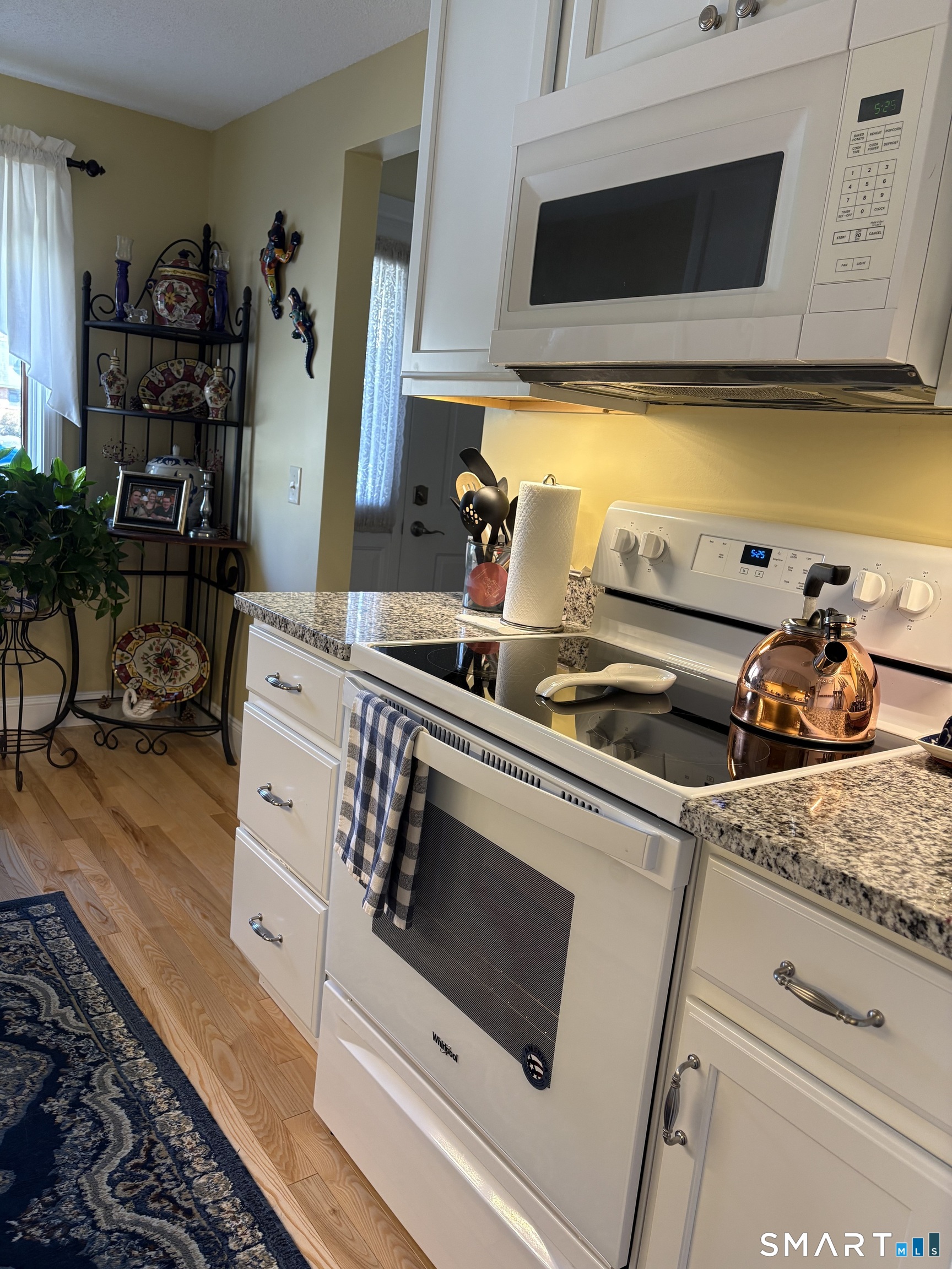 32 Upper Pattagansett Road, Unit 30 East Lyme, CT 06333 - Photo 5 of 28 a kitchen with stainless steel appliances a stove a microwave a sink and cabinets