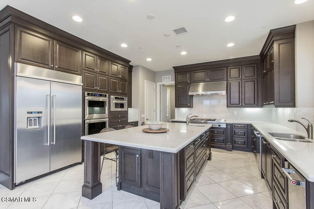 7342 Nicklaus Road Moorpark, CA 93021 - Photo 2 of 55 a kitchen with stainless steel appliances granite countertop a sink stove and refrigerator