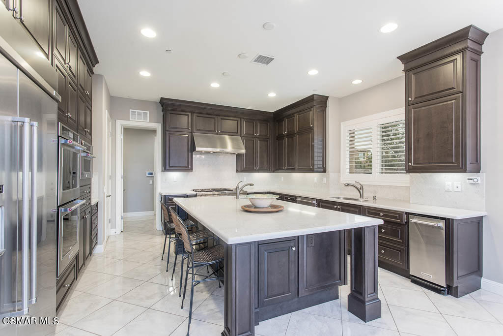 7342 Nicklaus Road Moorpark, CA 93021 - Photo 17 of 55 a kitchen with a sink a counter top space stainless steel appliances and cabinets