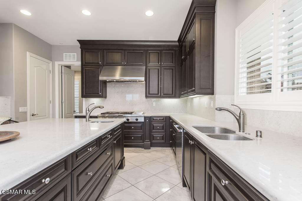 7342 Nicklaus Road Moorpark, CA 93021 - Photo 18 of 55 a kitchen with a sink stove top oven and cabinets