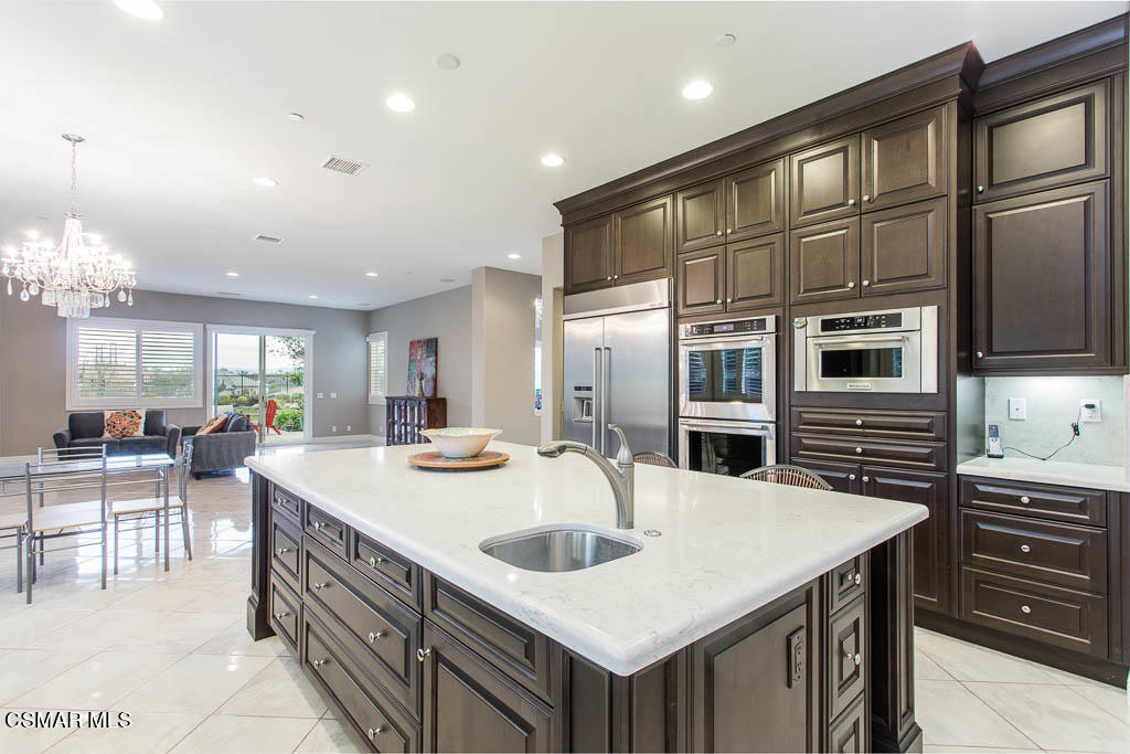7342 Nicklaus Road Moorpark, CA 93021 - Photo 20 of 55 a kitchen with stainless steel appliances granite countertop a sink and cabinets