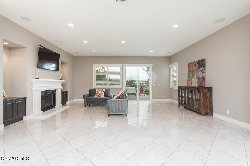 7342 Nicklaus Road Moorpark, CA 93021 - Photo 23 of 55 a living room with furniture a fireplace and a flat screen tv