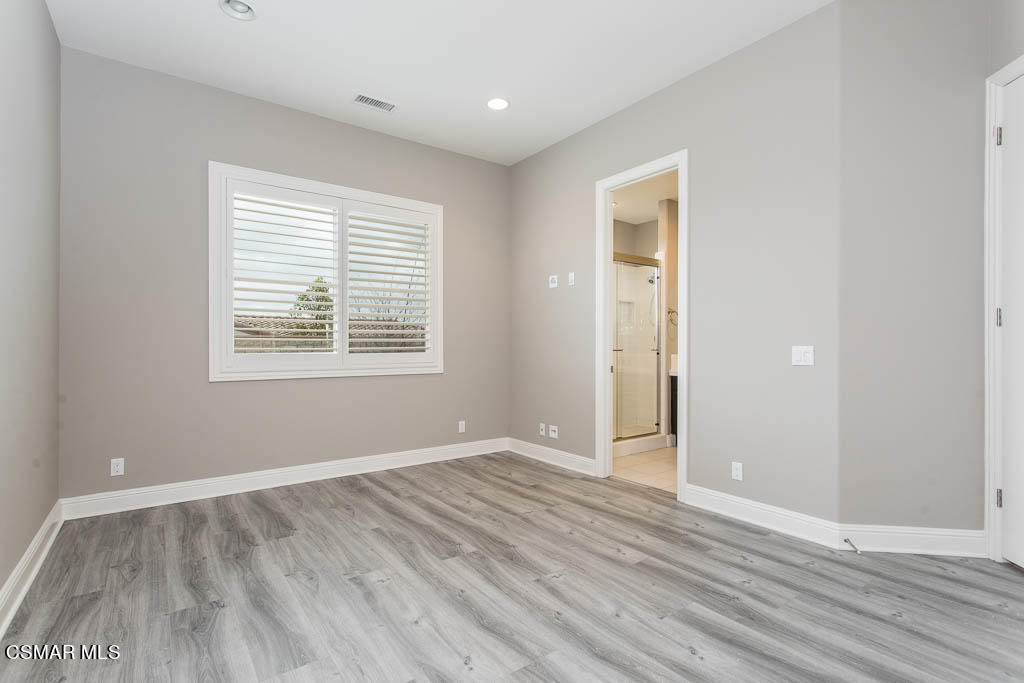 7342 Nicklaus Road Moorpark, CA 93021 - Photo 29 of 55 a view of an empty room with wooden floor and a window