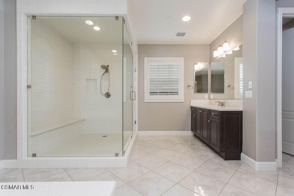7342 Nicklaus Road Moorpark, CA 93021 - Photo 36 of 55 a bathroom with a granite countertop sink mirror and shower