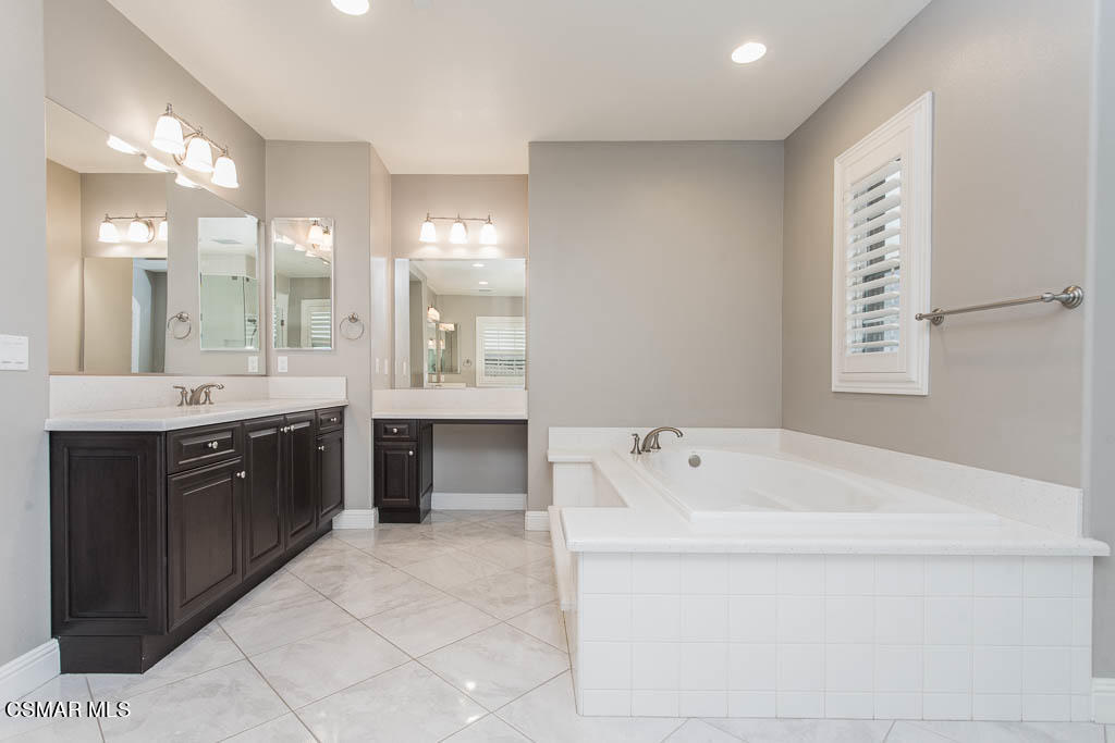 7342 Nicklaus Road Moorpark, CA 93021 - Photo 37 of 55 a spacious bathroom with a tub sink and mirror