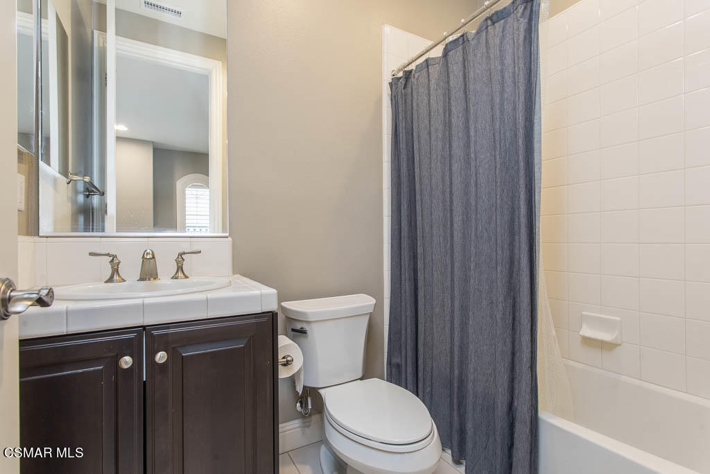 7342 Nicklaus Road Moorpark, CA 93021 - Photo 46 of 55 a bathroom with a toilet a sink a vanity and mirror