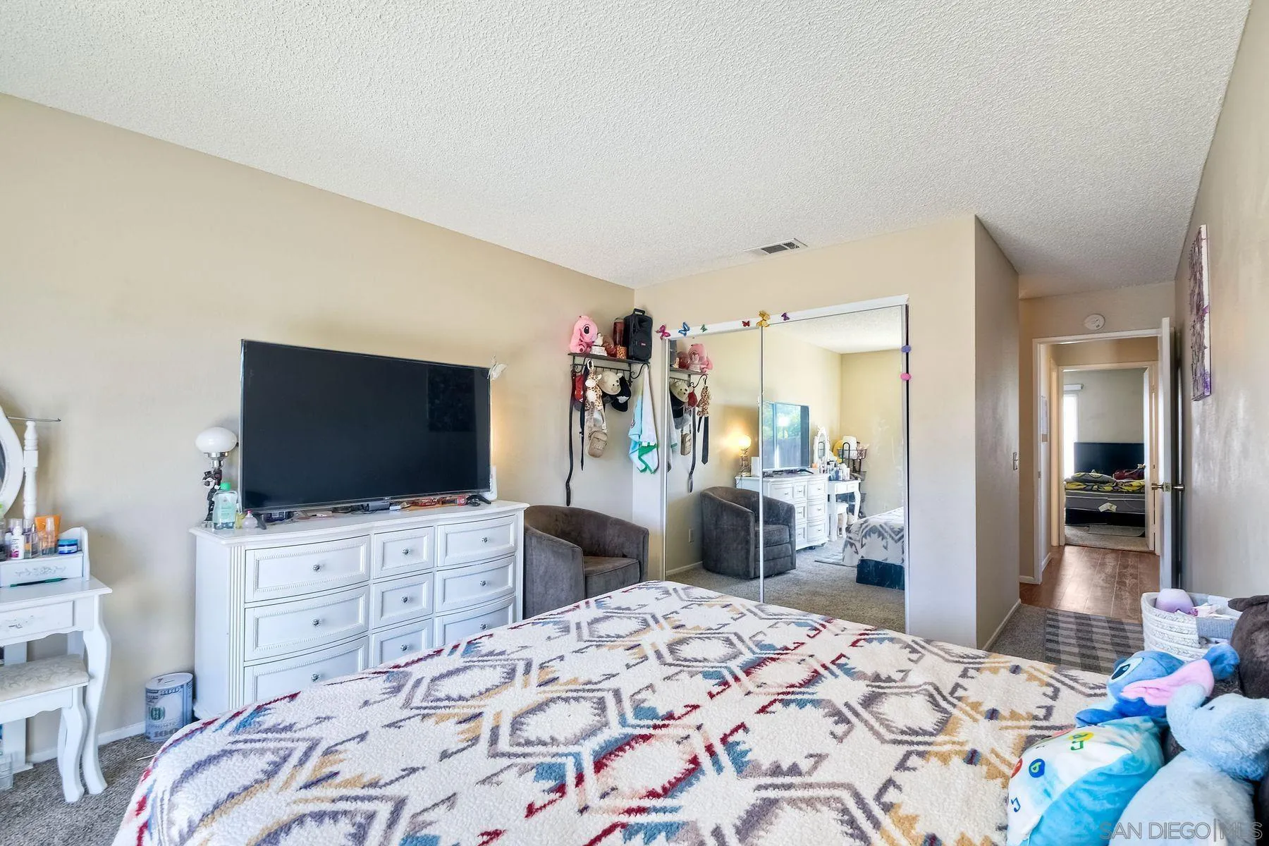 1160 Corral Glen Escondido, CA 92026 - Photo 13 of 16 a bedroom with a bed and a flat screen tv