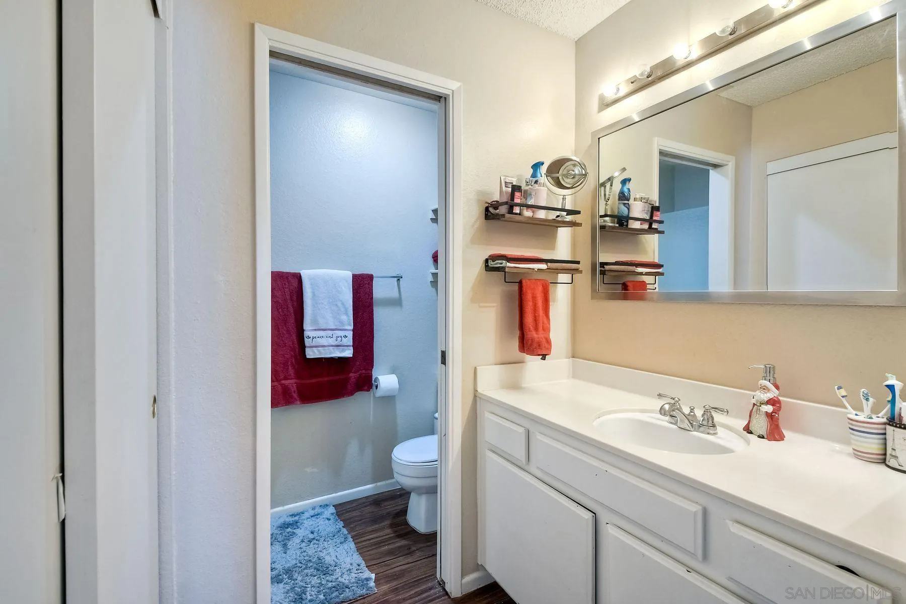 1160 Corral Glen Escondido, CA 92026 - Photo 14 of 16 a bathroom with a sink and a mirror