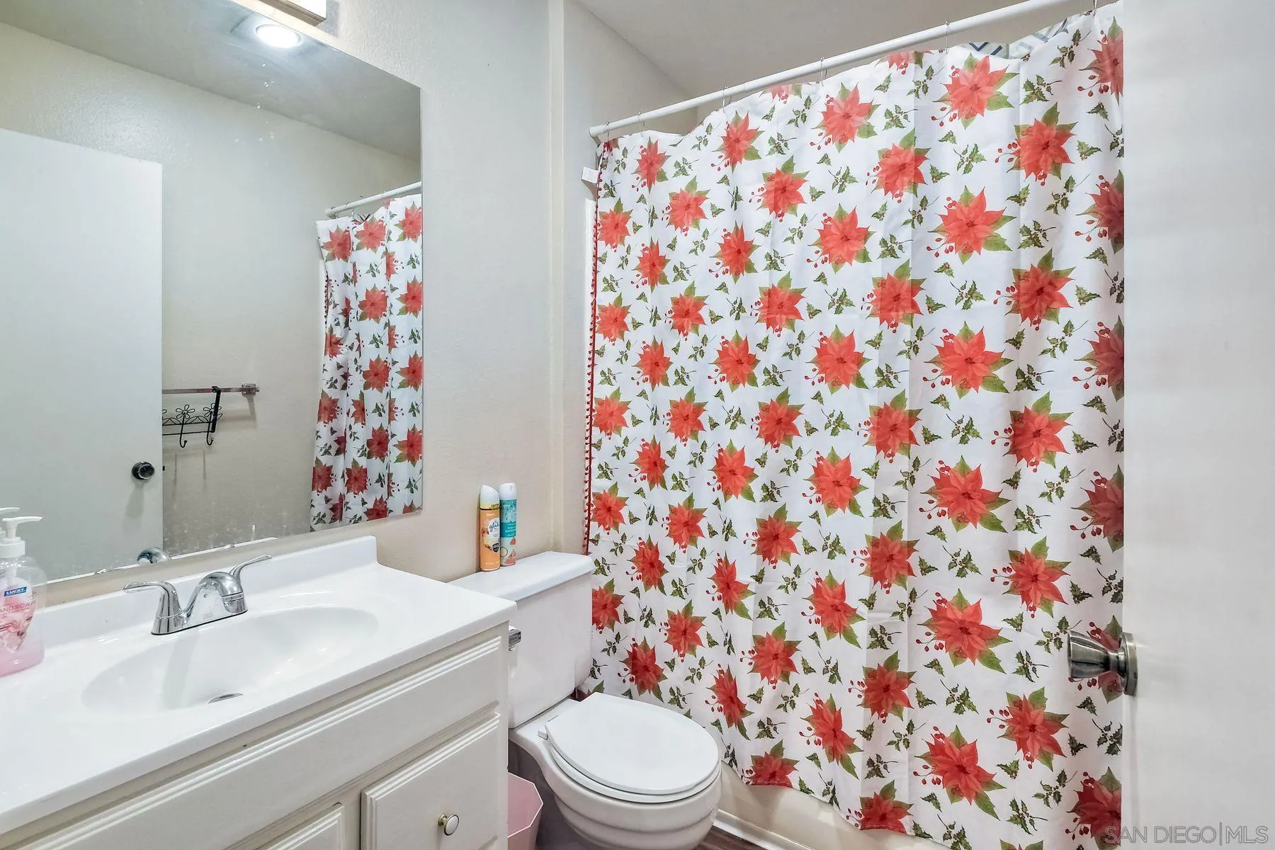 1160 Corral Glen Escondido, CA 92026 - Photo 15 of 16 a bathroom with a sink toilet and shower curtain