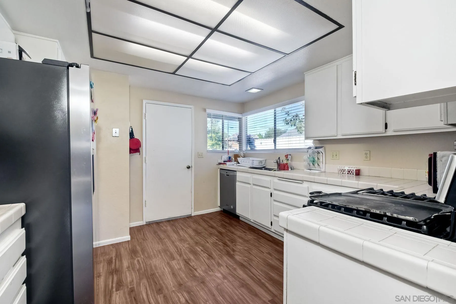 1160 Corral Glen Escondido, CA 92026 - Photo 7 of 16 a kitchen with a refrigerator and a stove top oven