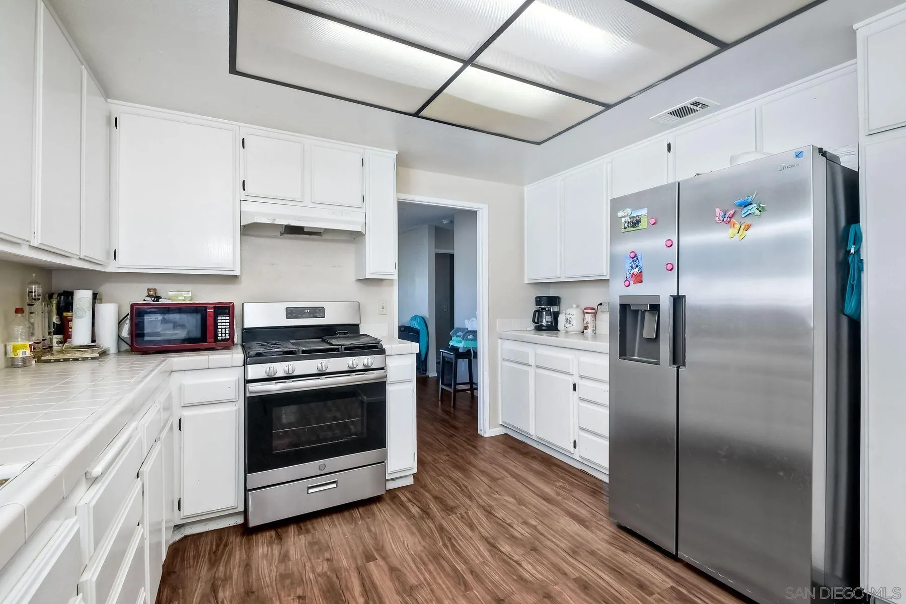 1160 Corral Glen Escondido, CA 92026 - Photo 9 of 16 a kitchen with cabinets stainless steel appliances and wooden floor